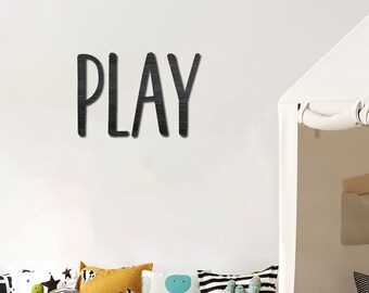 May include: A children's playroom with a white tent, various pillows, and a green rug. The word "PLAY" is displayed on the wall. Toy cars and a cactus plant are also visible, creating a playful atmosphere.
