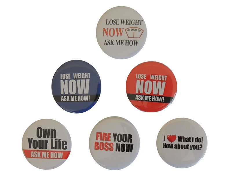 May include: Five round button badges with motivational slogans. The badges are white with red and black text. The slogans are "Lose Weight Now Ask Me How", "Lose Weight Now Ask Me How", "Own Your Life Ask Me How", "Fire Your Boss Now", and "I love what I do! How about you?"