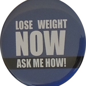 May include: A blue round button with white text that reads "Lose Weight Now Ask Me How!"