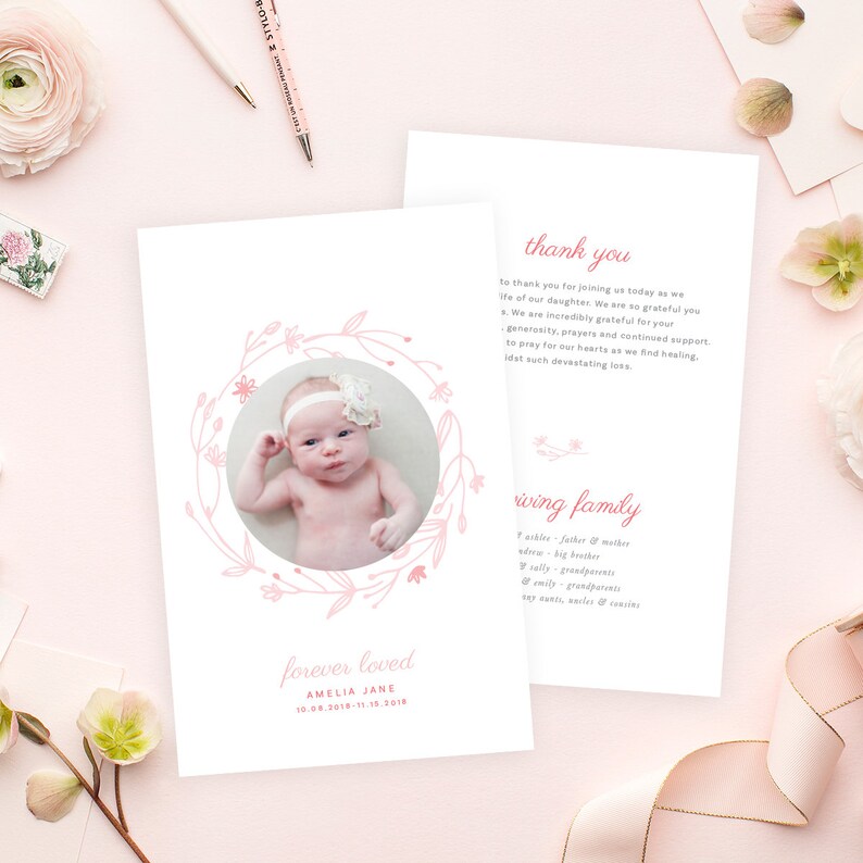 May include: Pink floral wreath with a photo of a baby girl in the centre. The text "forever loved" is below the wreath, followed by the baby's name, Amelia Jane, and birth and death dates. The text "thank you" and "loving family" are on a separate card with a list of family members.
