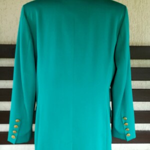 May include: A teal blazer with gold buttons. The blazer is long-sleeved and has a classic style.