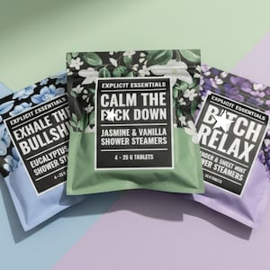 May include: Three shower steamer packages with bold text. The packages are blue, green, and purple, with floral patterns. The text on the packages reads "Exhale the Bullshit", "Calm the F*ck Down", and "B*tch Relax".
