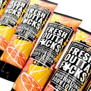 May include: Four bottles of body lotion with a bright yellow and orange citrus design. The bottles are labeled "Fresh Outta F*cks" with the text "Red Hibiscus & Sugared Citrus Moisturizing Body Lotion" and "Explicit Essentials".