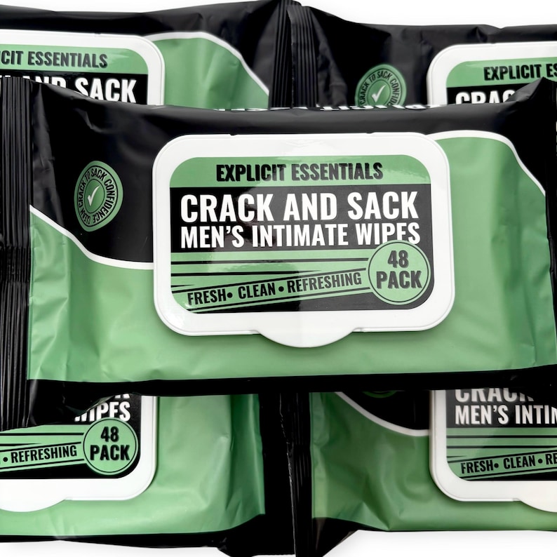 May include: Multiple packs of "Explicit Essentials Crack and Sack Men's Intimate Wipes" are displayed. The packaging is black and green with white text. Each pack contains 48 wipes and is labeled "Fresh, Clean, Refreshing."
