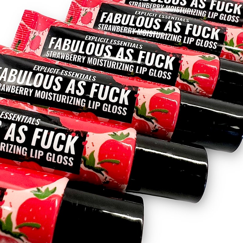May include: Five tubes of strawberry flavored lip gloss with the words "Fabulous as Fuck" and "Explicit Essentials" printed on the labels. The tubes are red and black with a strawberry design.