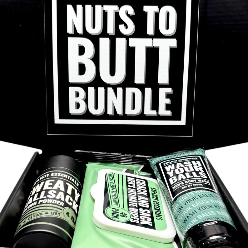 May include: A black box set with the text "NUTS TO BUTT BUNDLE" in white. The box contains a black container of "SWEAT ALLSACK" powder, a pack of "CRACK AND SACK" wipes, and a tube of "WASH YOUR BALLS" body wash.