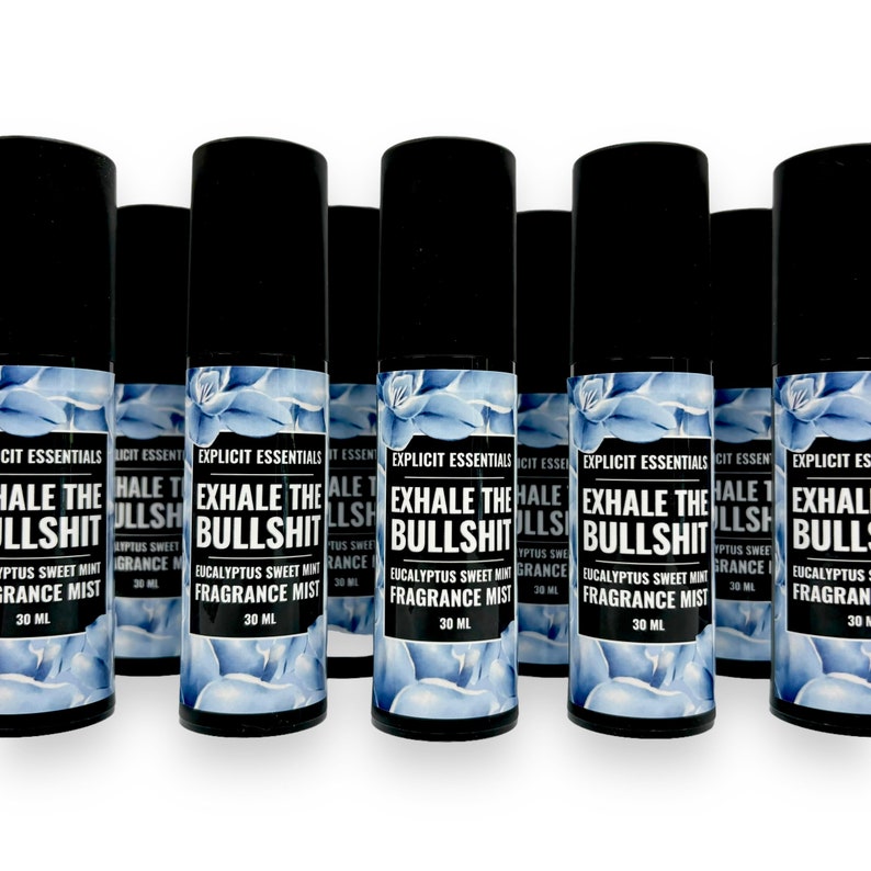 Puede incluir: Varias botellas de spray negras con etiquetas que dicen "EXHALE THE BULLSHIT" y "Eucalyptus Sweet Mint Fragrance Mist". Las etiquetas presentan un dise&ntilde;o floral azul. Cada botella contiene 30 ml.