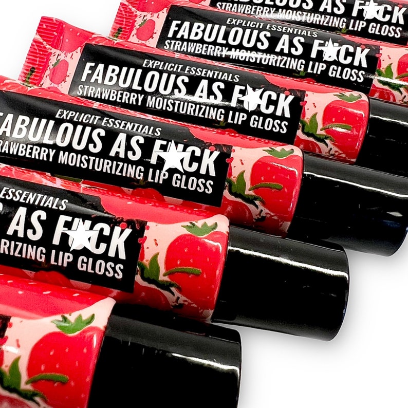May include: Five tubes of strawberry flavored lip gloss with black caps. The tubes are labeled "Fabulous as F*ck" and "Explicit Essentials Strawberry Moisturizing Lip Gloss".