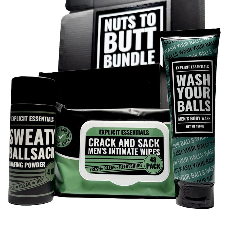 May include: A black and green bundle of Explicit Essentials products. Includes a tube of body wash, a container of chafing powder, and a pack of intimate wipes. The text "Nuts to Butt Bundle" is visible on the box.