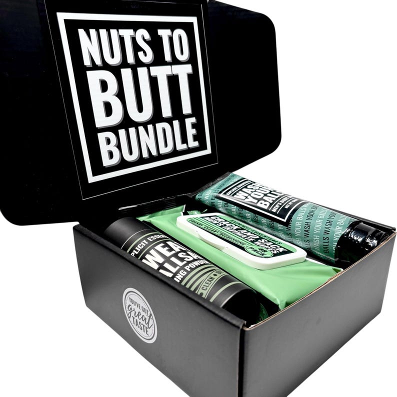 May include: A black gift box labelled "Nuts to Butt Bundle" contains several products. Inside are two tubes, a small rectangular package, and a green cloth. The tubes are black and green, and the package is white and green. The box has the words "You've got great taste" on it.