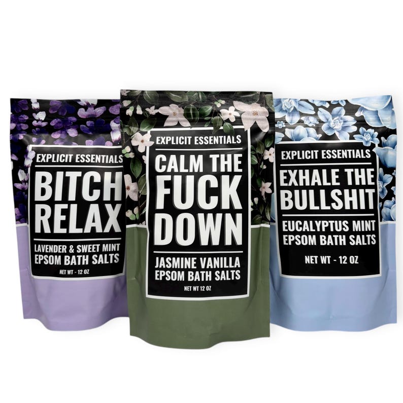May include: Three bags of Epsom bath salts with bold text. The bags are lavender, green, and blue, each with a floral pattern. The text on the bags reads "Bitch Relax", "Calm the Fuck Down", and "Exhale the Bullshit". Each bag contains 12 oz of bath salts.