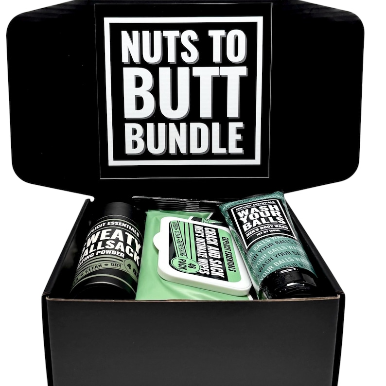 May include: A black gift box with the text "Nuts to Butt Bundle" on the lid. Inside are personal care items: a container of "Sweat Allsack" powder, "Crack and Sack" wipes, and a tube of "Wash Your Balls" body wash.