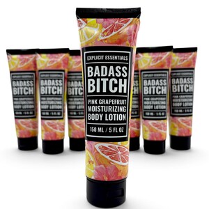 May include: A collection of six squeeze tubes of Explicit Essentials Badass Bitch Pink Grapefruit Moisturizing Body Lotion. Each tube features a pink grapefruit and hibiscus floral pattern, a black cap, and a label stating 150 ml / 5 fl oz.
