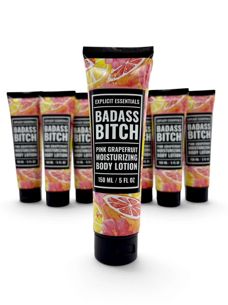 May include: A collection of six squeeze tubes of Explicit Essentials Badass Bitch Pink Grapefruit Moisturizing Body Lotion. Each tube features a pink grapefruit and hibiscus floral pattern, a black cap, and a label stating 150 ml / 5 fl oz.