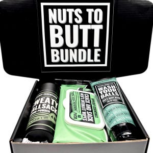May include: A black box set labelled "NUTS TO BUTT BUNDLE" containing a black container of "WEATY ALLSACK" powder, a green pack of "CRACK AND SACK" wipes, and a tube of "WASH YOUR BALLS" body wash.
