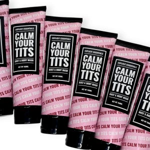 May include: Several pink tubes of bust and body wash are arranged in a row. Each tube has a black cap and features the text "CALM YOUR TITS" in a bold, white font. The product is labeled "Explicit Essentials" and contains 150ml.