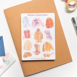 May include: A sheet of stickers featuring illustrations of winter outerwear, including coats, sweaters, hats, scarves, boots, and sunglasses. The text "Winter Outerwear" and "Occasional Motto" are printed on the sheet.
