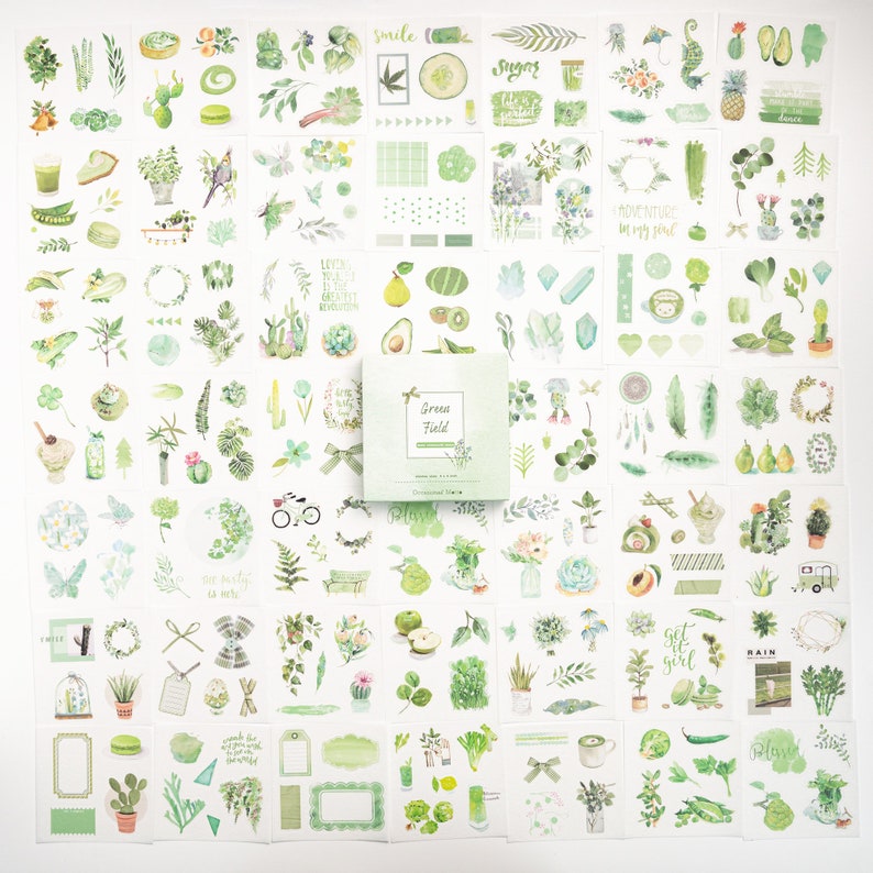 May include: A sheet of 100 green and white stickers featuring various illustrations of plants, leaves, and flowers. The stickers are arranged in a grid pattern and include text such as "Green Field", "Smile", "Adventure in my soul", and "Get it girl".