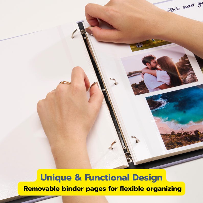 May include: A white three-ring binder with metal rings containing clear plastic sleeves. The sleeves hold printed photographs of a couple and a beach landscape. The text "Bob soccer ga" is visible at the top, and the binder features metal rings.