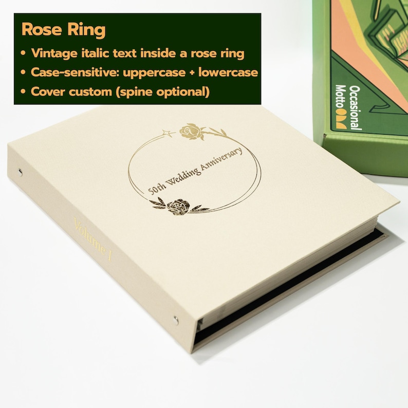 May include: A cream-colored binder featuring a gold foil-stamped circular rose design on the front cover. The text 50th Wedding Anniversary is printed in a vintage italic font inside the rose ring. The word Volume 1 is visible on the spine.