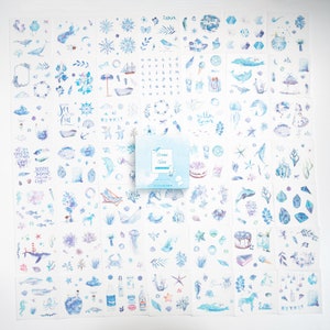 May include: A set of 36 ocean-themed stickers featuring watercolor illustrations of seashells, starfish, jellyfish, seahorses, whales, dolphins, boats, and more. The stickers are on a white background and come in a box labeled "Ocean Vibes".