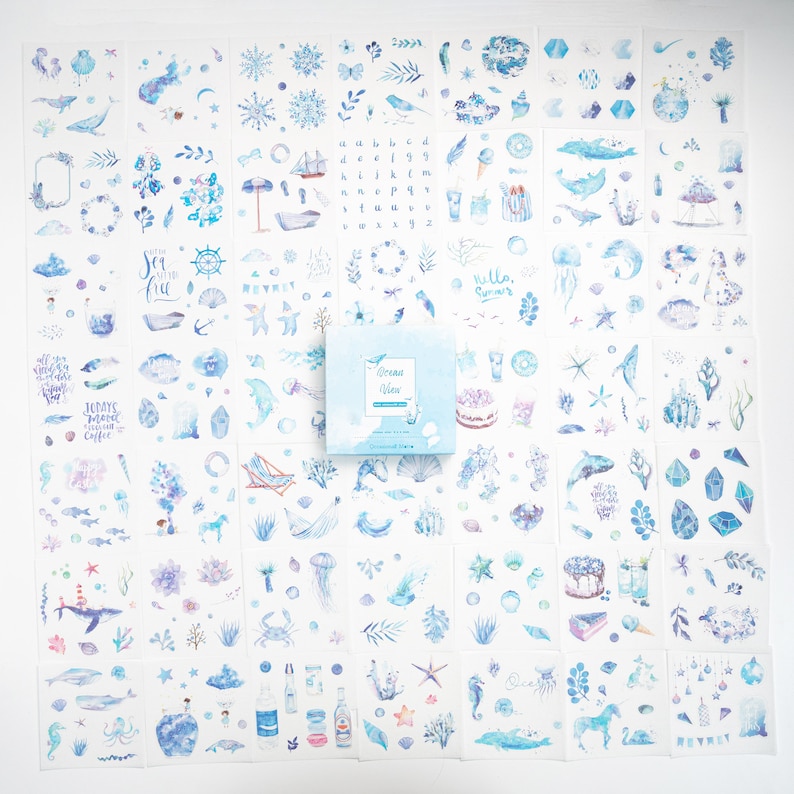 May include: A set of 36 ocean-themed stickers featuring watercolor illustrations of seashells, starfish, jellyfish, seahorses, whales, dolphins, boats, and more. The stickers are on a white background and come in a box labeled "Ocean Vibes".
