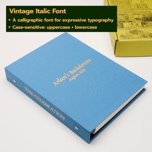 May include: A light blue binder with gold foil text on the cover reading Arleen's Bachelorette August, 2025 and on the spine reading THE CELEBRATION. The binder features a metal ring mechanism and is positioned near a yellow box with line art.