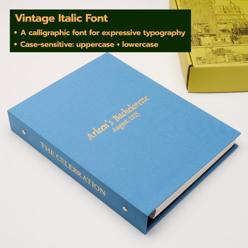 May include: A light blue binder with gold foil text on the cover reading Arleen's Bachelorette August, 2025 and on the spine reading THE CELEBRATION. The binder features a metal ring mechanism and is positioned near a yellow box with line art.