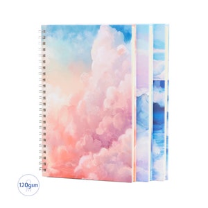May include: A set of three spiral bound notebooks with watercolour cloud designs. The covers feature a gradient of pink, blue, and purple.