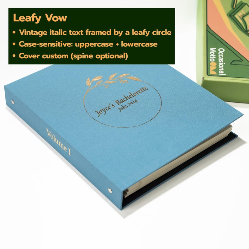 May include: A light blue binder with a gold foil-stamped leafy circle design on the cover. The text inside the circle reads Joyce's Bachelorette July, 2024. The word Volume I is printed in gold on the spine. The binder has metal ring hardware.