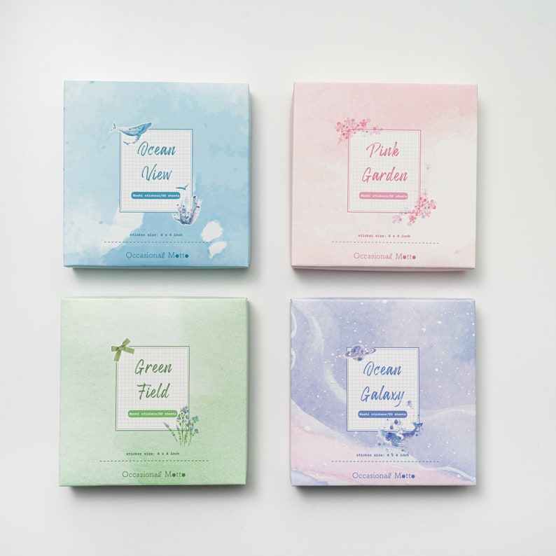 May include: Four boxes of decorative stickers with watercolor designs. The boxes are labeled "Ocean View", "Pink Garden", "Green Field", and "Ocean Galaxy". Each box has a sticker size of 4.8 x 6.8 inches and is labeled "Occasional Matte".