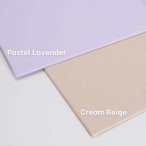May include: Two rectangular fabric swatches are displayed, one in pastel lavender and one in cream beige. The text "Pastel Lavender" is printed on the lavender fabric, and the text "Cream Beige" is printed on the cream beige fabric.