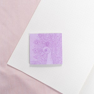 May include: A purple sticky note with a detailed line drawing of a peacock with its feathers spread out.