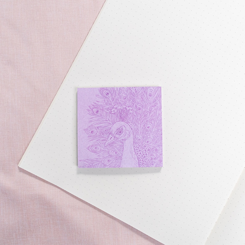 May include: A purple sticky note with a detailed line drawing of a peacock with its feathers spread out.
