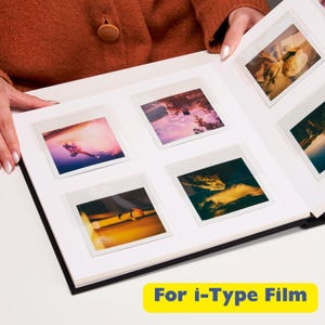 May include: Black photo album with white pages and clear plastic sleeves for holding instant photos. The album is open to reveal several photos, including a sunset, a mountain, and a person jumping. The text "For i-Type Film" is printed on the bottom of the image.