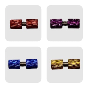 May include: Four sets of metal screw-on caps in different colors: orange, purple, blue, and gold. Each set consists of two caps connected by a screw.