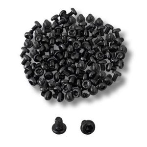 May include: A large quantity of black screws with a star-shaped head. The screws are scattered on a white surface.