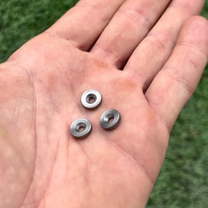 May include: Three silver metal rings with a textured surface.
