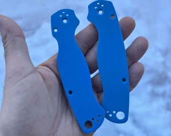 May include: Two blue plastic knife scales with holes for mounting hardware.