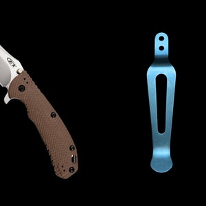 May include: A brown and silver pocket knife with a textured handle and a blue titanium deep carry pocket clip.