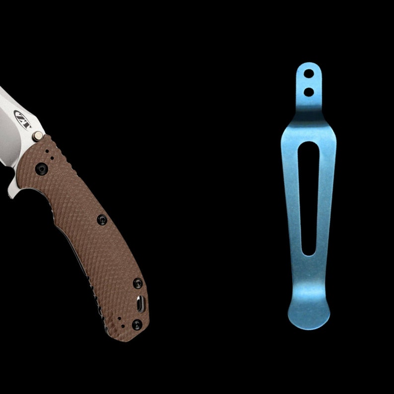 May include: A brown and silver pocket knife with a textured handle and a blue titanium deep carry pocket clip.