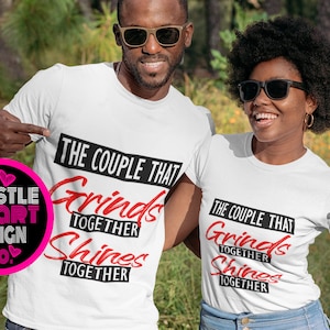 May include: A couple wearing white t-shirts with the text "The Couple That Grinds Together Shines Together" in black and red. The couple is standing in a grassy field.