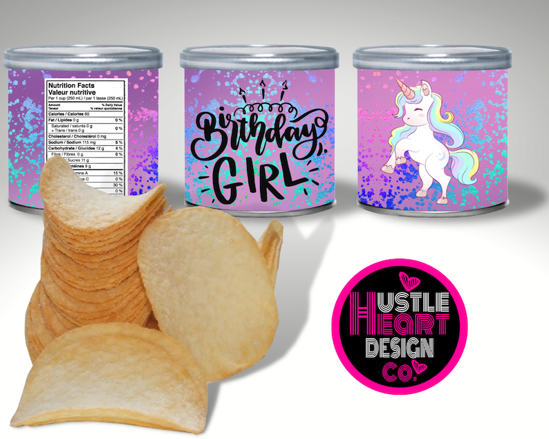 May include: A set of three pink and purple cans with a unicorn design and the text "Birthday Girl". The cans are decorated with glitter and iridescent paint splatters. The cans are sitting on a white surface.