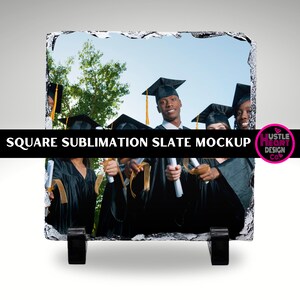 May include: A square sublimation slate mockup featuring a group of graduates in black caps and gowns holding diplomas. The slate is on a stand and has a rough, natural texture.