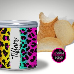 May include: A colorful, personalized chip can with a leopard print design. The can has a white stripe with the name "Tiffany" written on it. The can is sitting on a white surface. The text "Hustle Heart Design Co." is on a pink circle with a heart.