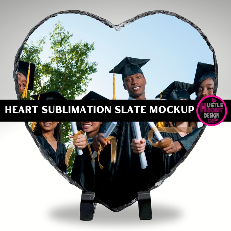 May include: Heart-shaped slate plaque with a sublimation design featuring a group of graduates in black caps and gowns holding diplomas. The slate is on a black stand. The text "HEART SUBLIMATION SLATE MOCKUP" is at the top of the image.