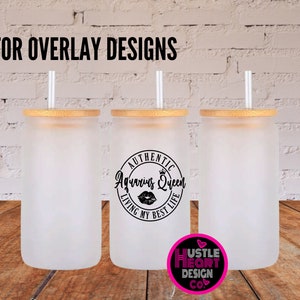 May include: Three frosted glass tumblers with bamboo lids and straws. The middle tumbler has a black and white graphic that says "Authentic Aquarius Queen Living My Best Life" with a crown and a red lip print.