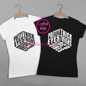 May include: Two t-shirts, one white and one black, with the text "Pretty Thick Eyes Thighs Good Vibes" printed in a 3D-style design.