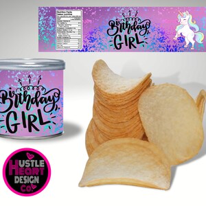 May include: A pink and blue can with a unicorn and the text "Birthday Girl" on it. The can is sitting on a white surface next to a stack of potato chips.