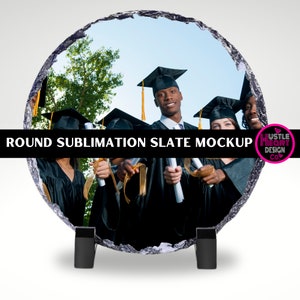 May include: Round sublimation slate mockup featuring a group of graduates in black caps and gowns holding diplomas. The slate is a light gray color with a rough texture. The background is a blurred image of a green tree and blue sky.